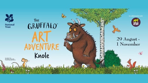 An illustration on a blue background of a brown creature with horns, big teeth orange eyes and spikes on its back, standing in some grass and next to a tree.
